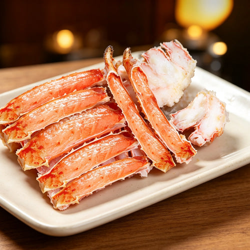 Split cooked king crab legs with bright orange-red shells and white meat